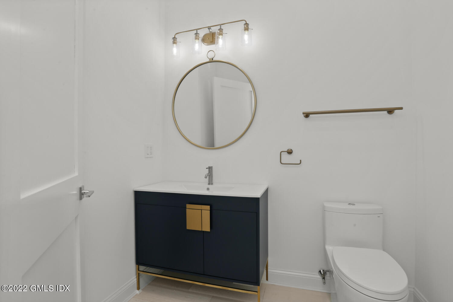 111 Mill Street, Unit PH Greenwich, CT 06830 - Photo 18 of 20 a bathroom with a toilet a sink and a mirror