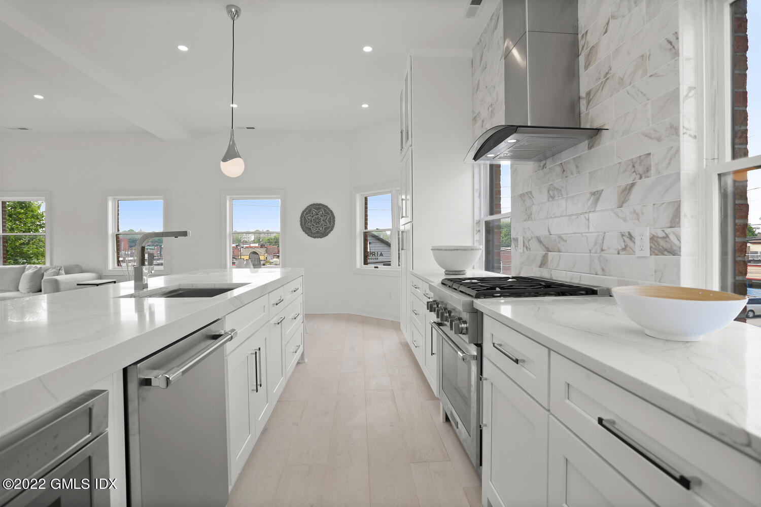 111 Mill Street, Unit PH Greenwich, CT 06830 - Photo 9 of 20 a kitchen with a sink stove and cabinets