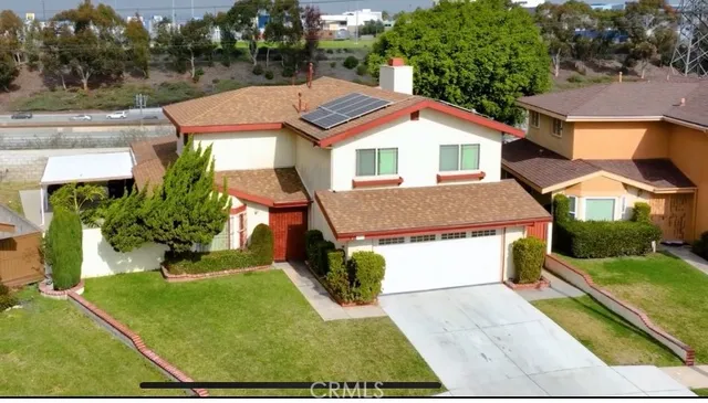 a aerial view of a house with a yard and potted plants