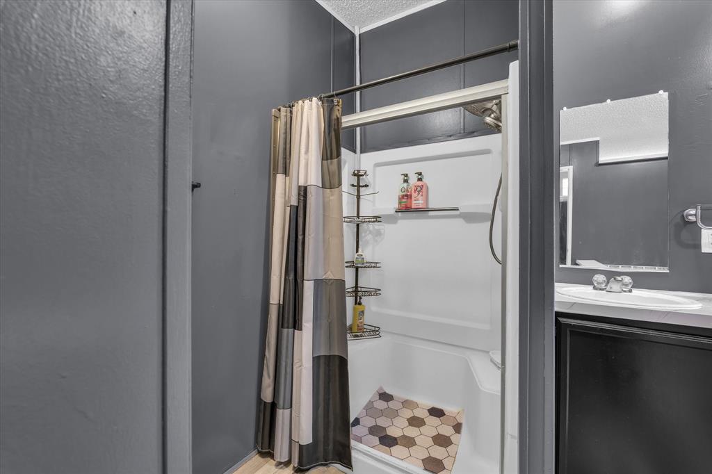 3615 Spring Valley Road Lorena, TX 76655 - Photo 18 of 33 Enclosed shower with a white surround and an integrated shelf