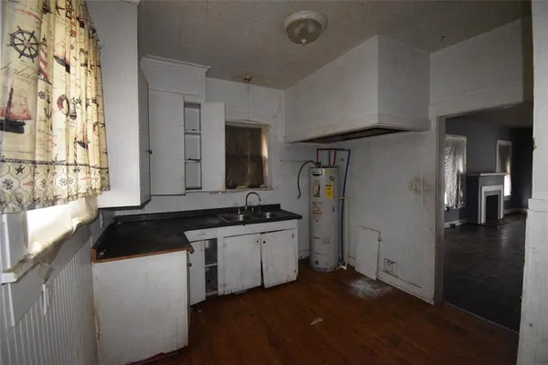 a kitchen with a refrigerator and a sink