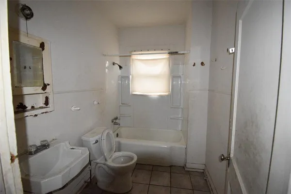 a bathroom with a granite countertop toilet and a shower