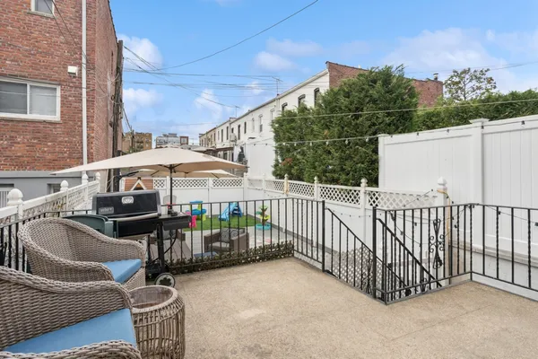 a view of a patio with a table and chairs