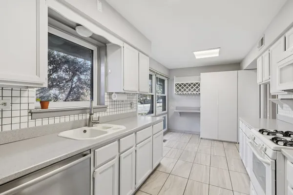 a kitchen with a sink appliances and cabinets