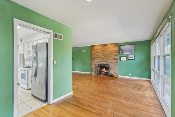 a view of a livingroom with a fireplace and toys