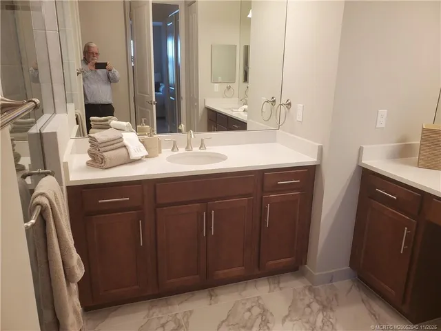 a bathroom with a double vanity sink and a mirror
