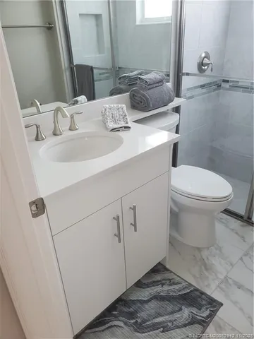 a bathroom with a sink toilet and vanity