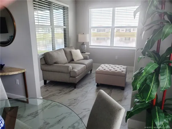 a bedroom with furniture and a large window