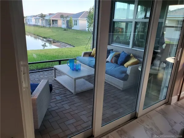 a view of a porch with furniture and garden