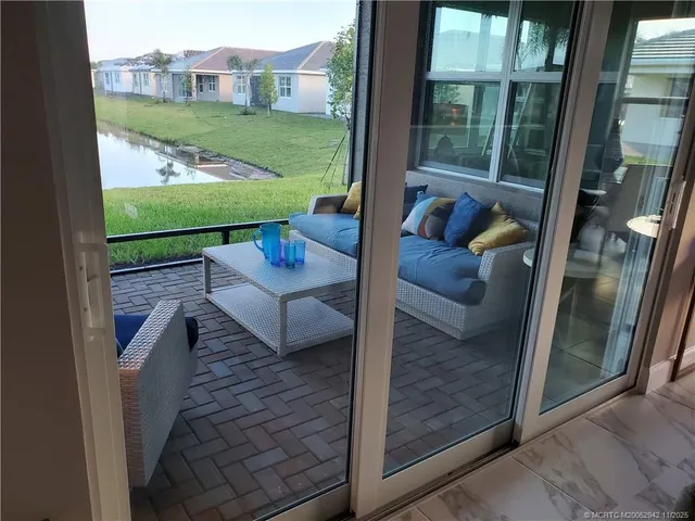 a view of a porch with furniture and garden