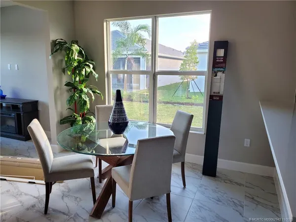 a view of a dining room with furniture window and wooden floor