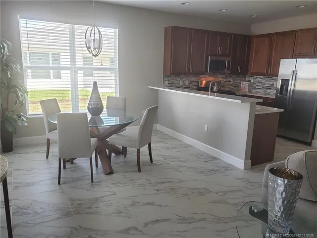 a view of a dining room with furniture and a window