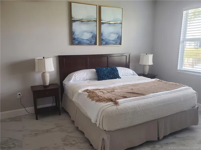 a bedroom with a bed and window