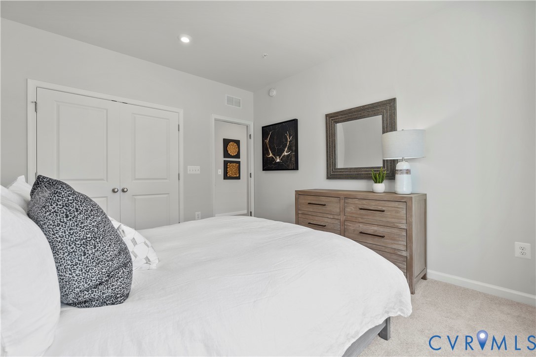 3611 Edna Path, Unit A Richmond, VA 23233 - Photo 21 of 32 a bedroom with a bed and a dresser