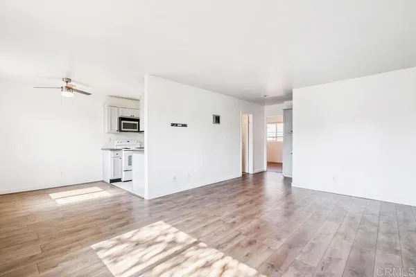 a view of a kitchen with wooden floor