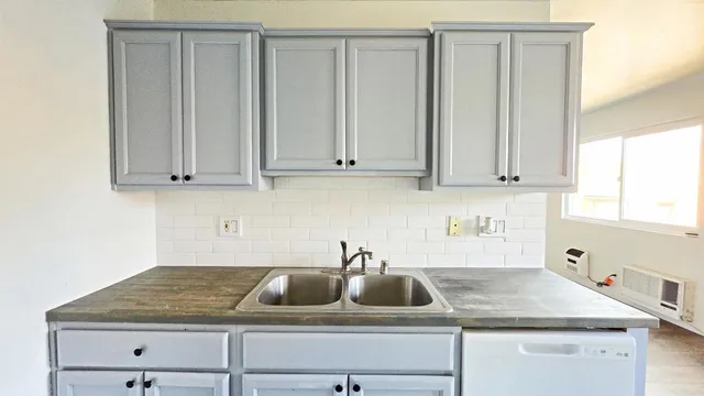 a kitchen with cabinets appliances and a sink