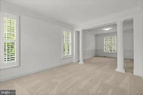 a view of an empty room and closet area