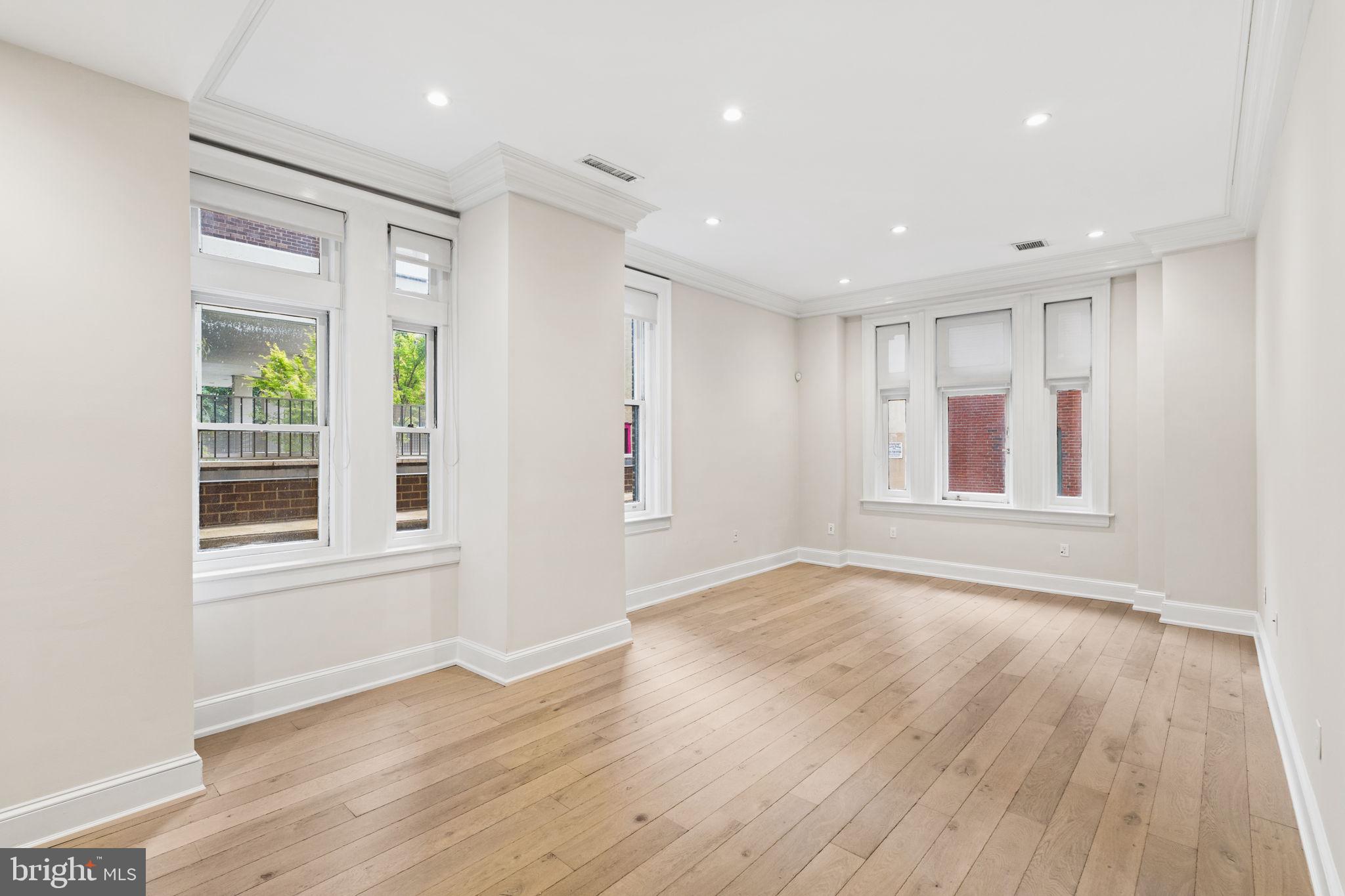 1830 Rittenhouse Square, Unit 1C Philadelphia, PA 19103 - Photo 4 of 32 a view of an empty room with wooden floor and a window