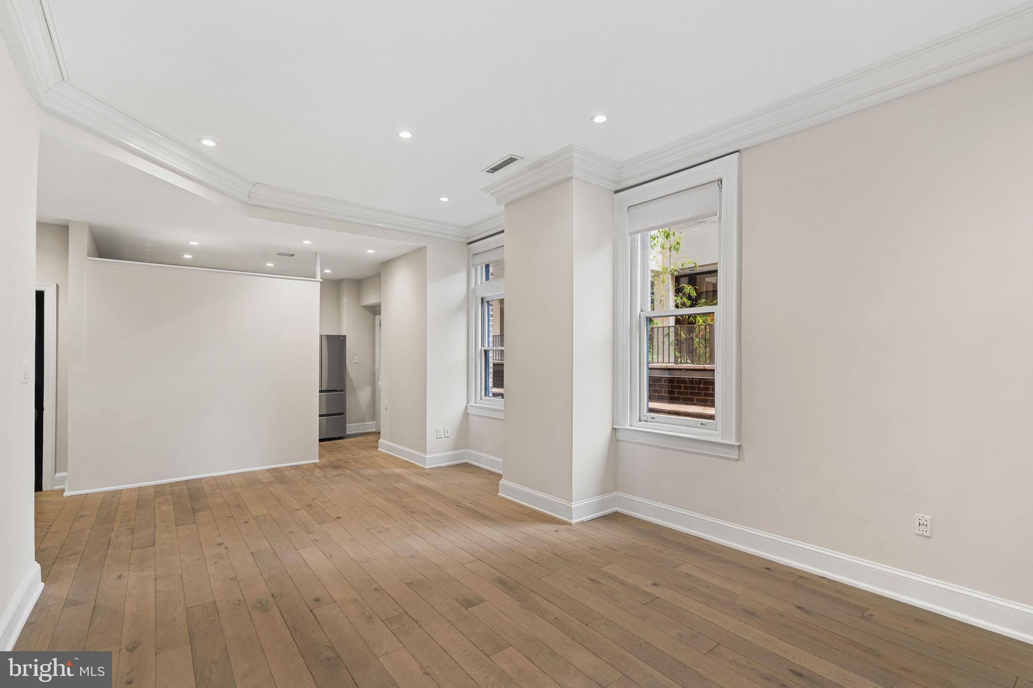 1830 Rittenhouse Square, Unit 1C Philadelphia, PA 19103 - Photo 9 of 32 a view of an empty room with wooden floor and a window