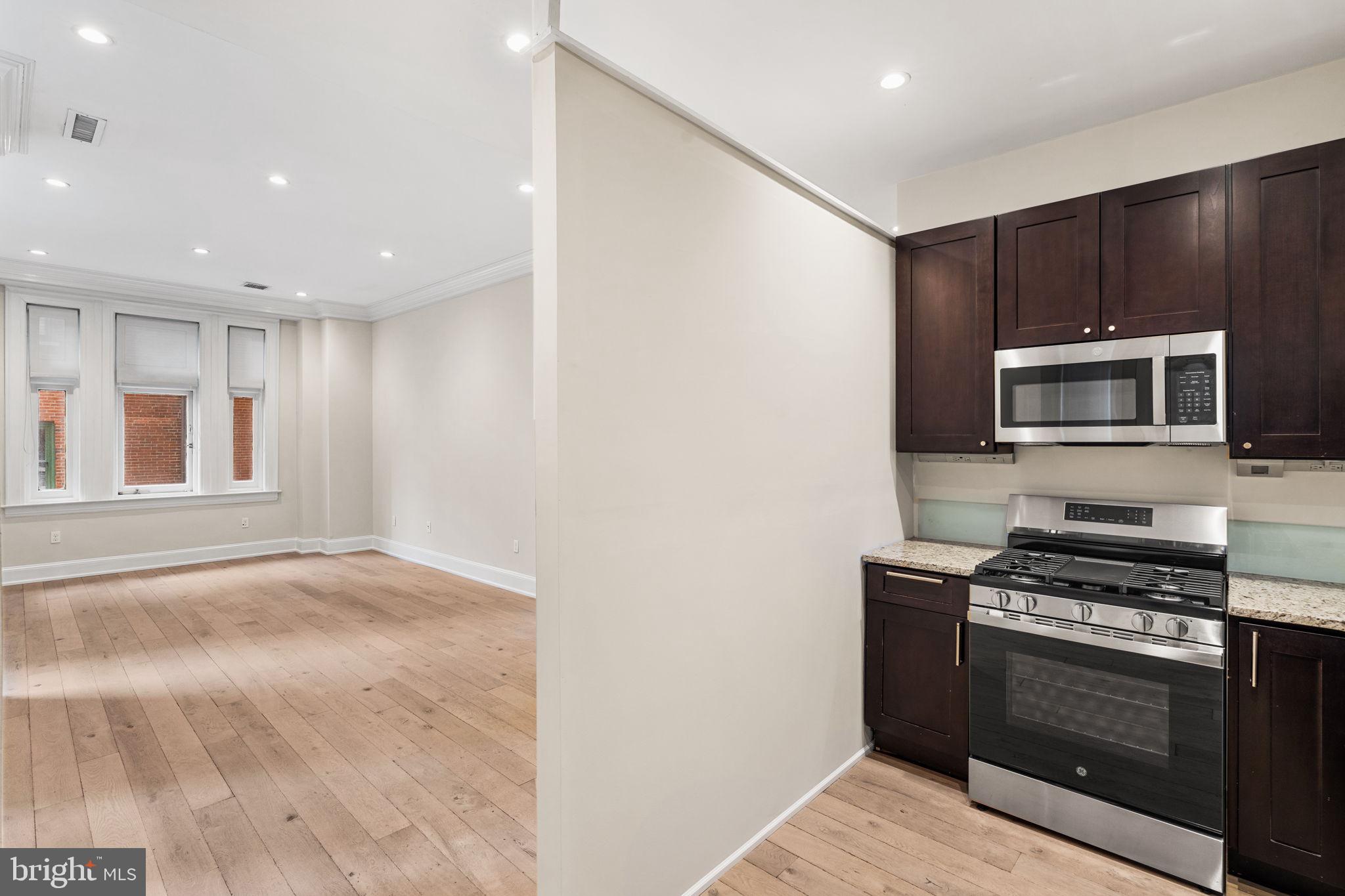 1830 Rittenhouse Square, Unit 1C Philadelphia, PA 19103 - Photo 10 of 32 a kitchen with a stove and a microwave