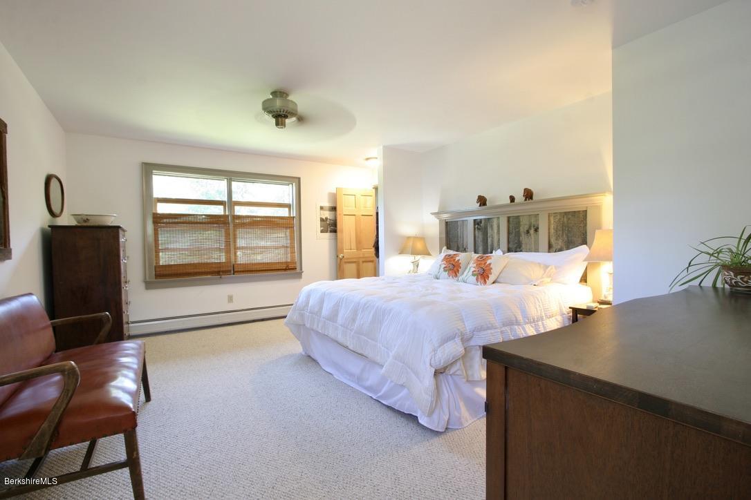 233 Main Road Monterey, MA 01245 - Photo 14 of 32 a bedroom with a bed and wooden floor