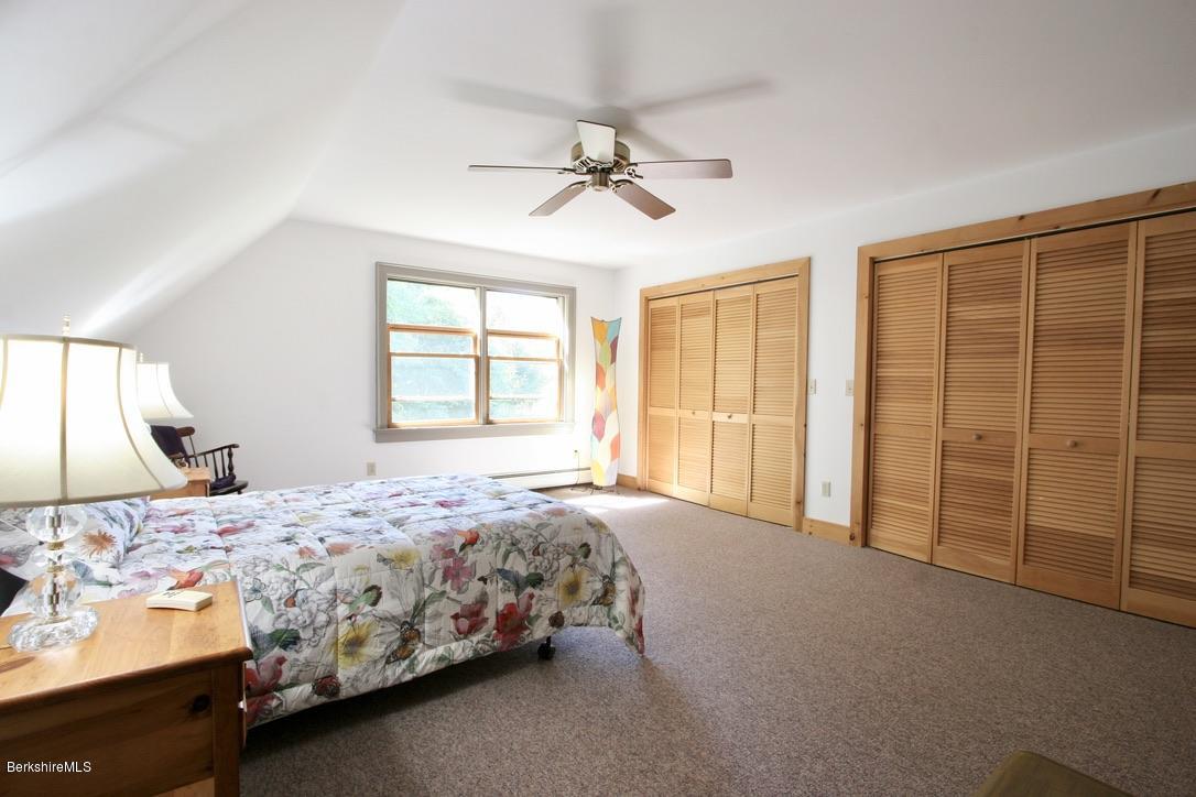 233 Main Road Monterey, MA 01245 - Photo 22 of 32 a bedroom with a bed and a window