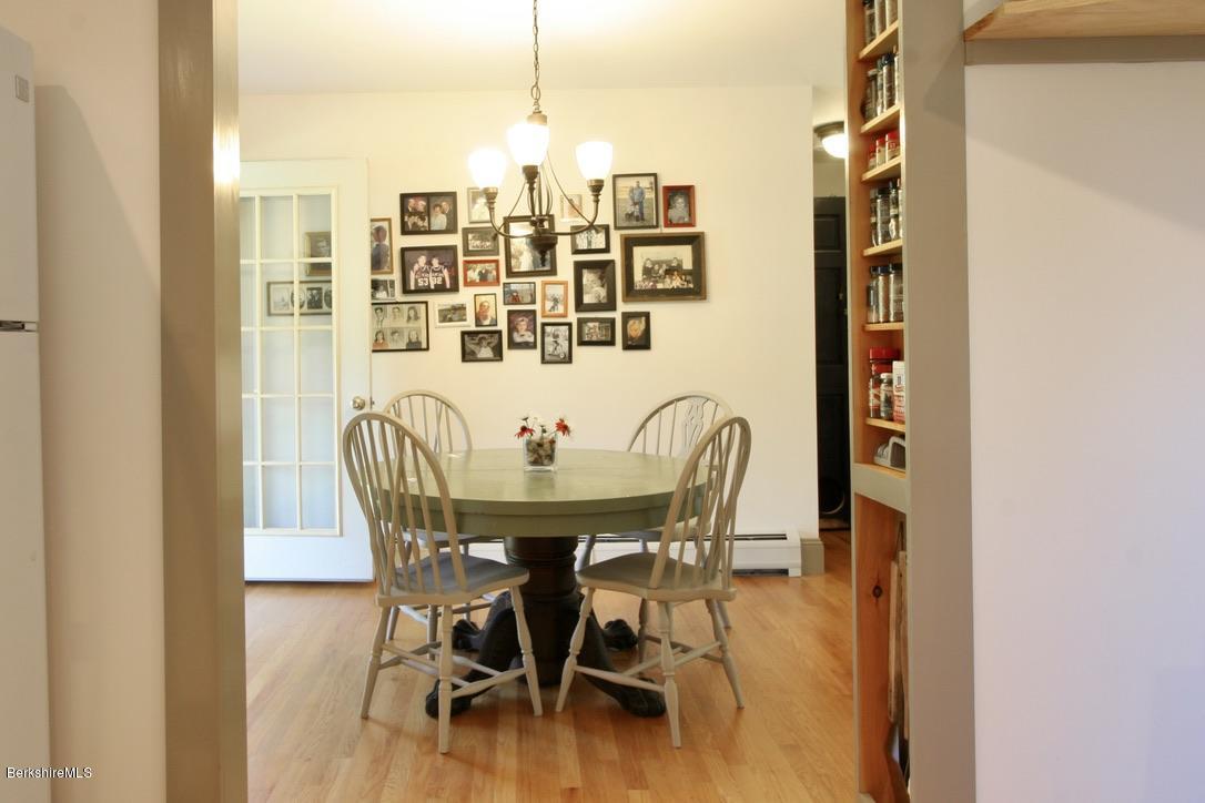 233 Main Road Monterey, MA 01245 - Photo 8 of 32 a view of a dining room with furniture and wooden floor