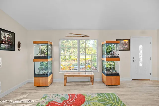 a bedroom with furniture and a wooden floor