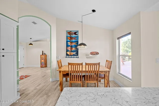a kitchen with stainless steel appliances granite countertop a stove a sink and a chandelier