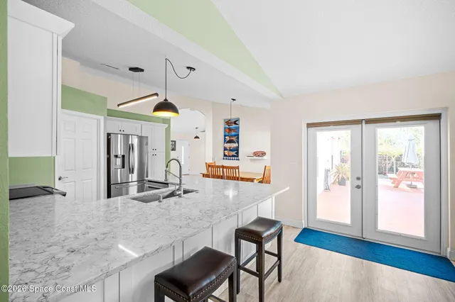a kitchen with cabinets and chandelier