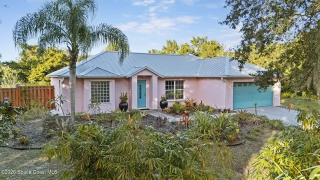 a front view of a house with a garden