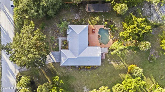 aerial view of a house with a yard