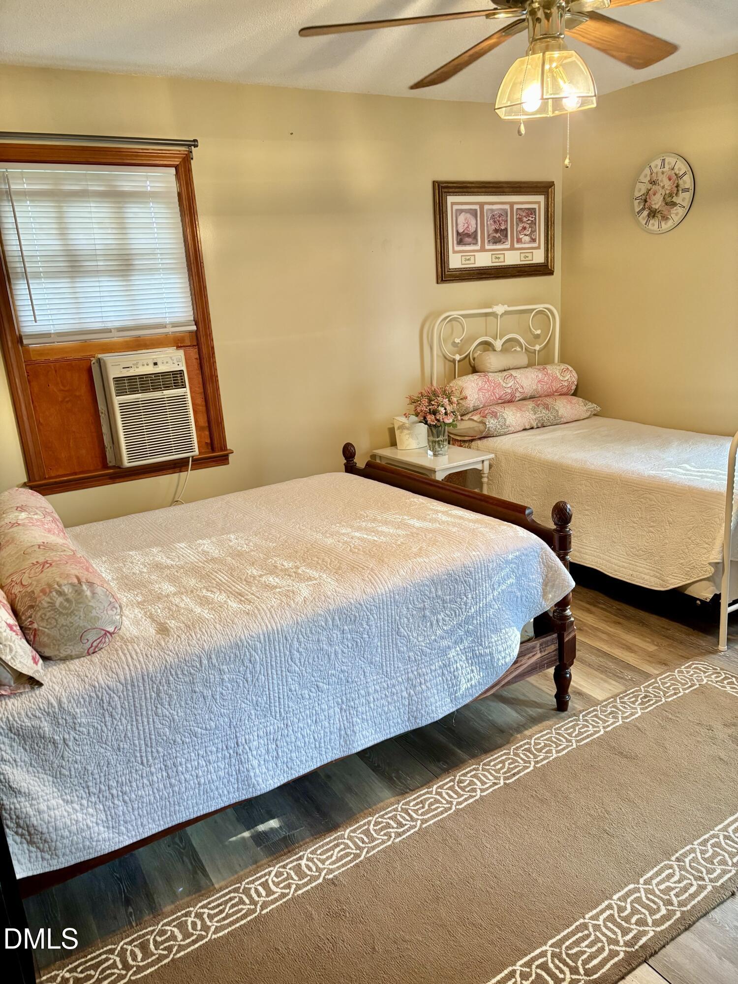 1088 Hyco Hills Road Semora, NC 27343 - Photo 11 of 27 a bedroom with a bed and a painting on the wall