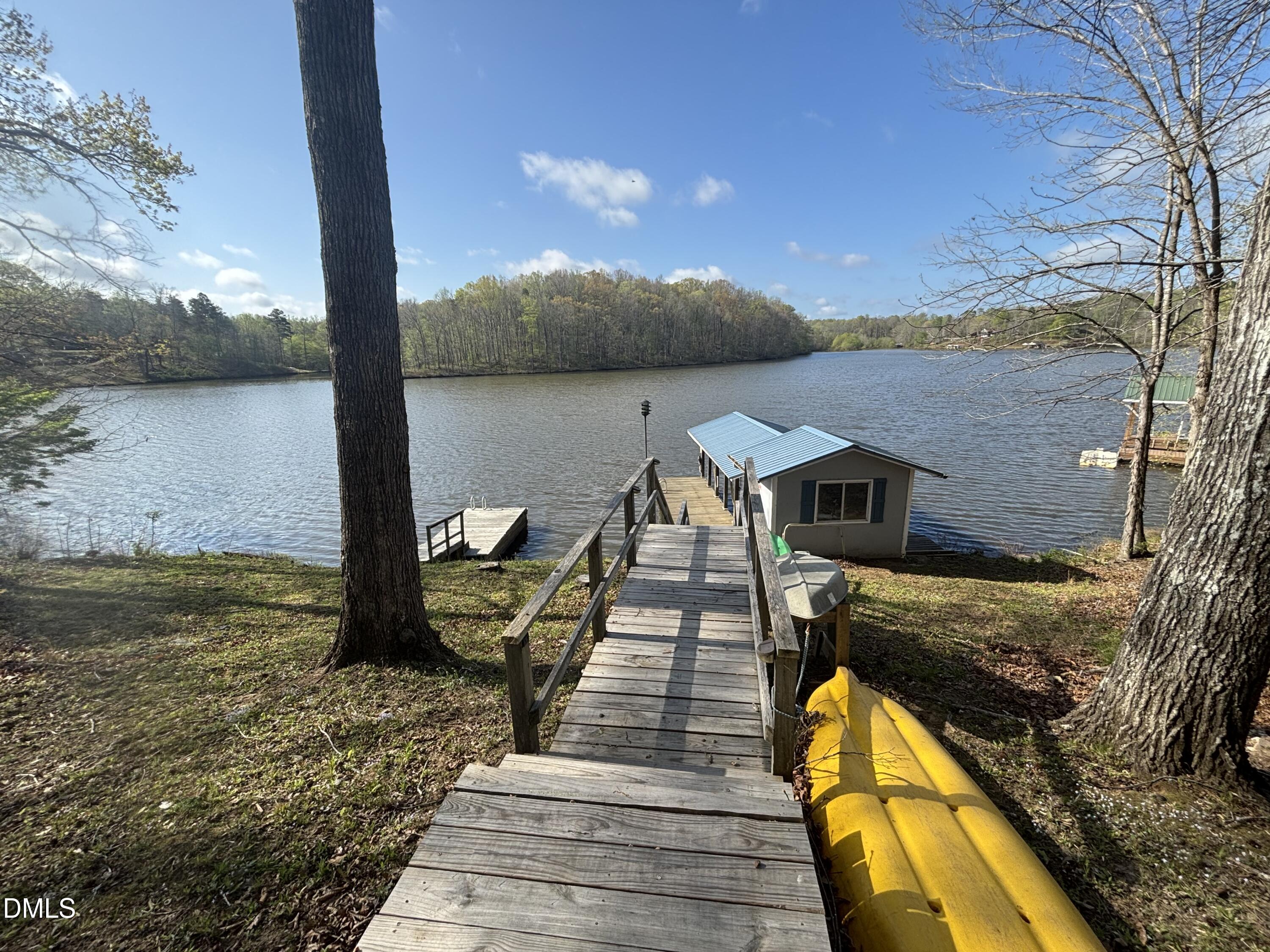 1088 Hyco Hills Road Semora, NC 27343 - Photo 13 of 27 a view of a wooden deck and lake view