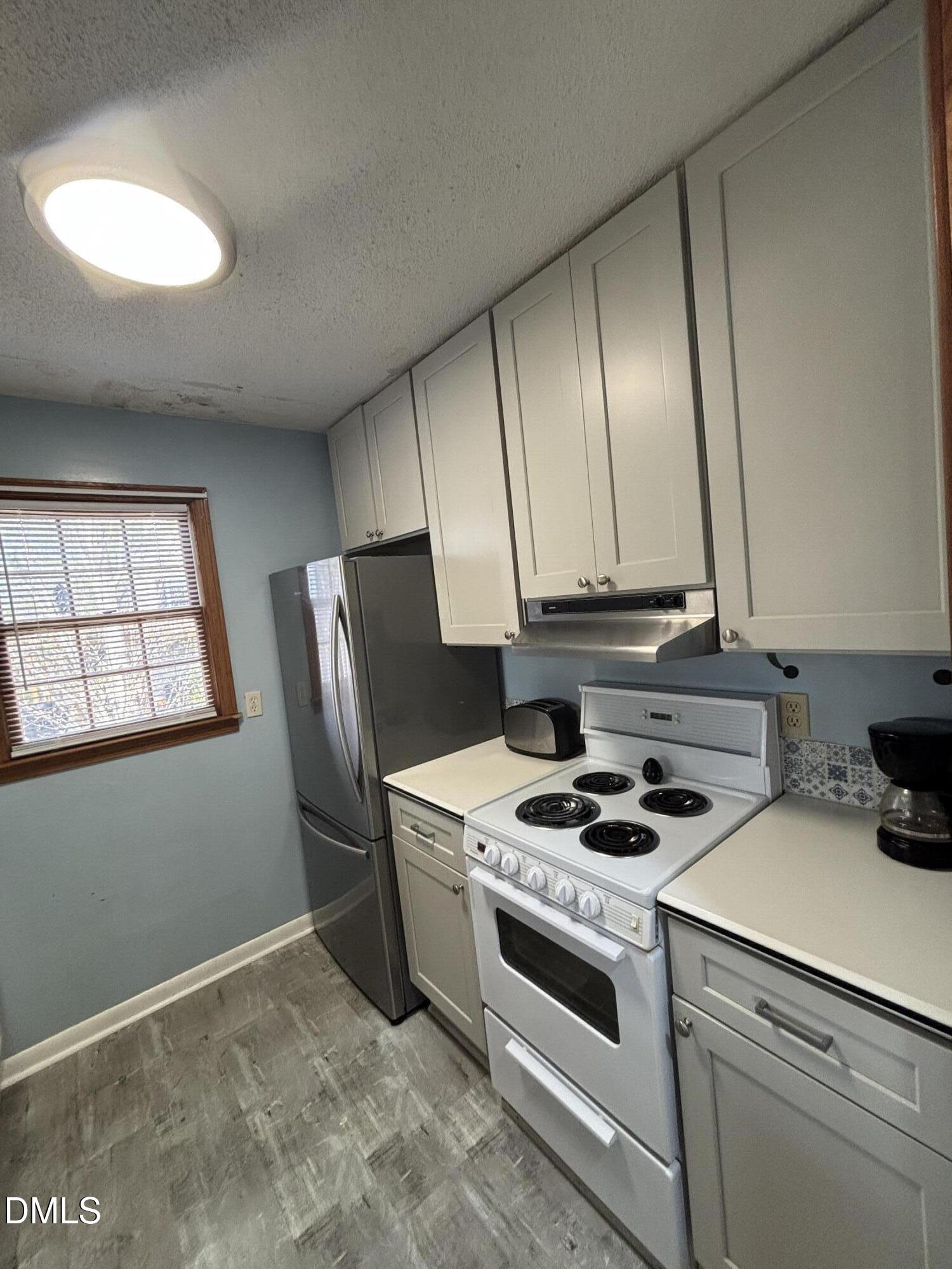 1088 Hyco Hills Road Semora, NC 27343 - Photo 5 of 27 a kitchen with a stove and a refrigerator