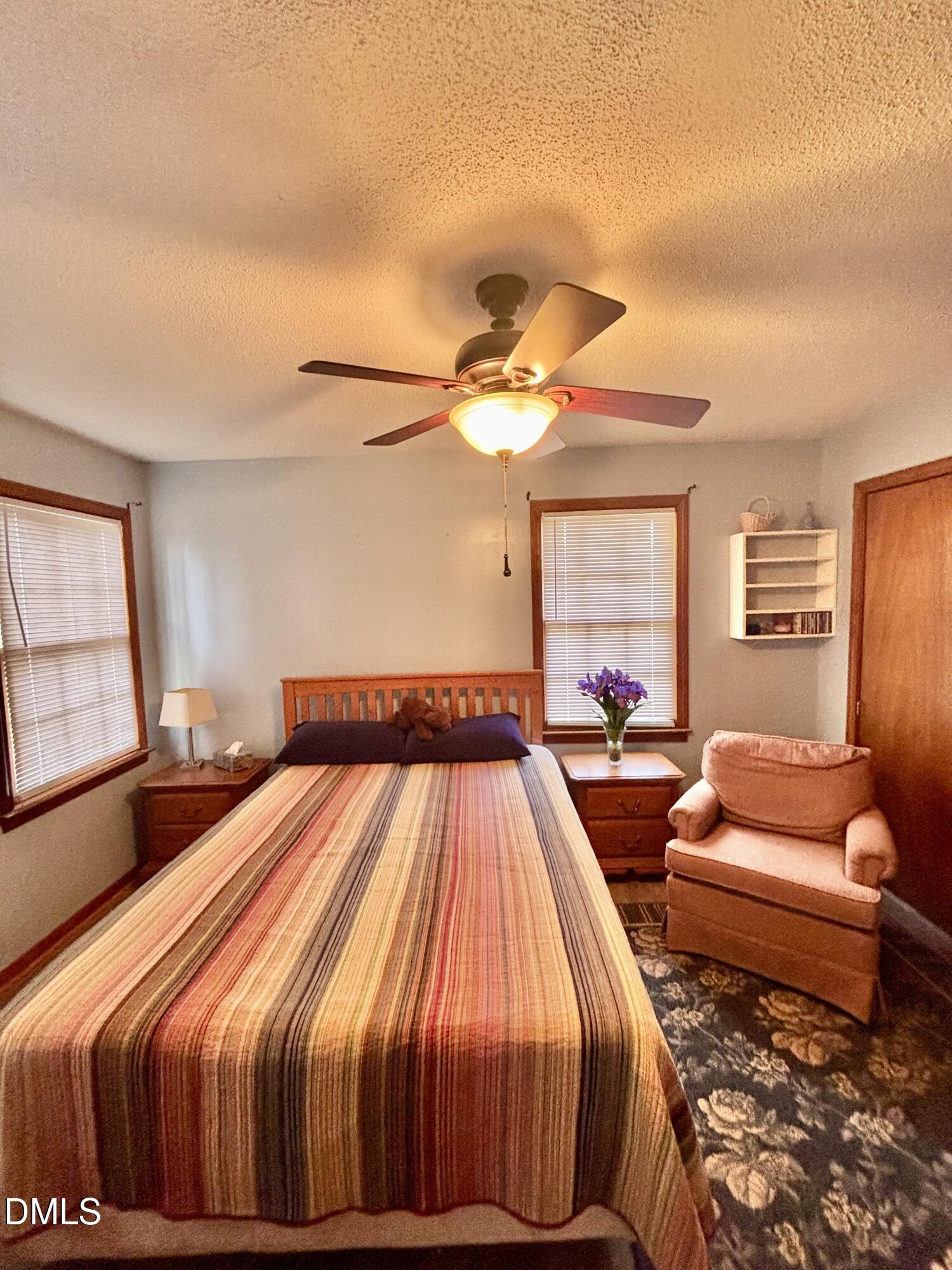 1088 Hyco Hills Road Semora, NC 27343 - Photo 7 of 27 a bedroom with a bed and wooden floor