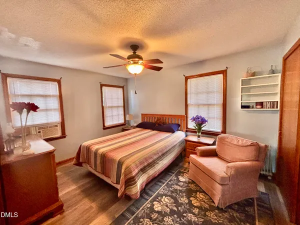 a bedroom with a bed and a painting on the wall