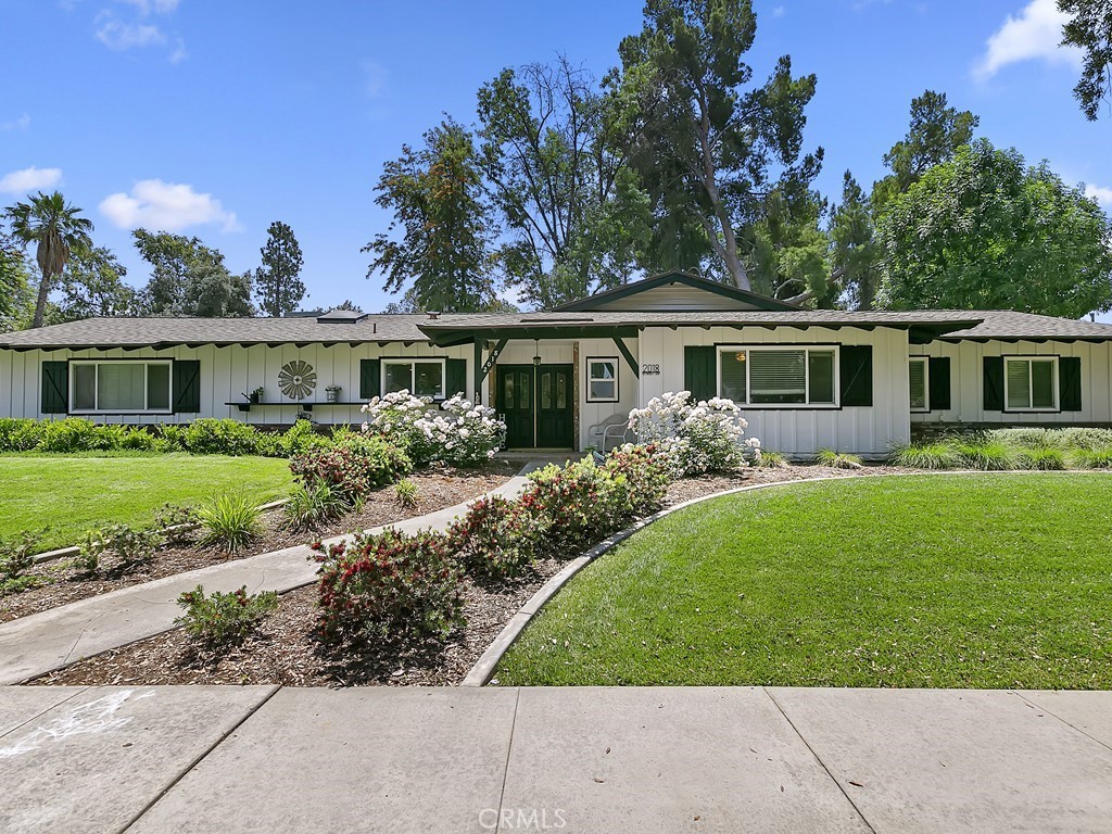 a view of house with yard and green space