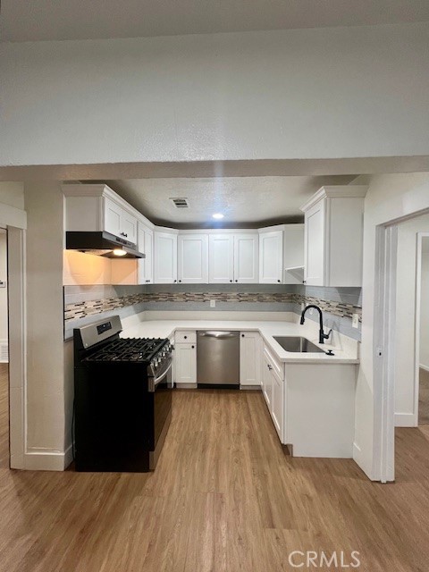 580 West 21st Street San Bernardino, CA 92405 - Photo 12 of 22 a kitchen with granite countertop a refrigerator stove top oven and sink