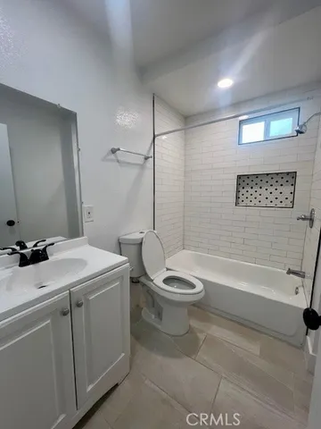 a bathroom with a sink a toilet and bathtub