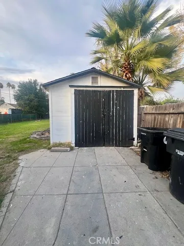 a view of backyard with potted plants and a palm tree