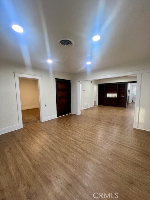 580 West 21st Street San Bernardino, CA 92405 - Photo 7 of 22 an empty room with wooden floor and natural light