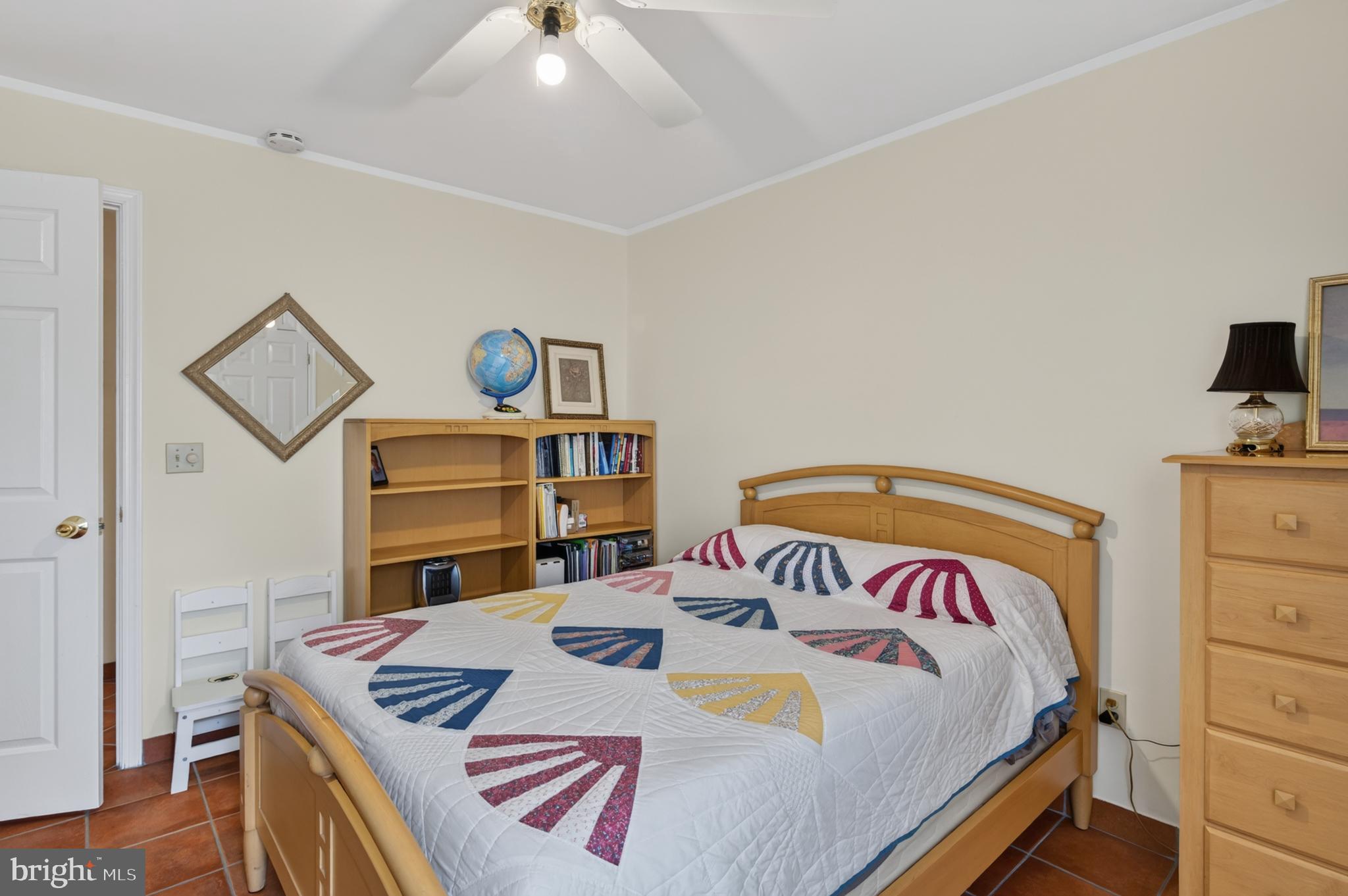 936 Bay Ridge Avenue, Unit 201 Annapolis, MD 21403 - Photo 37 of 40 a bedroom with a bed and a dresser in it
