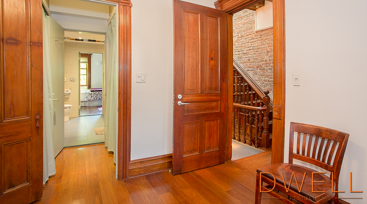 a view of an entryway with wooden floor and door