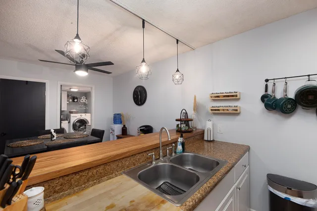 a kitchen with a stove a sink and a mirror