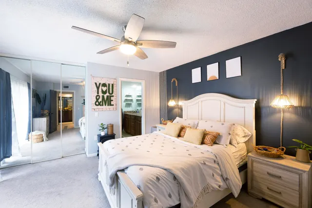 a bedroom with a bed and a chandelier