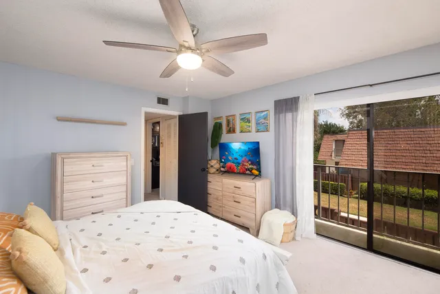 a bedroom with a bed and a flat tv screen