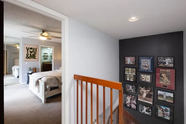 a spacious bedroom with a bed and a book shelf