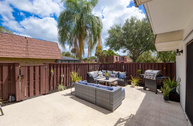 a outdoor space with patio fireplace and a potted plant