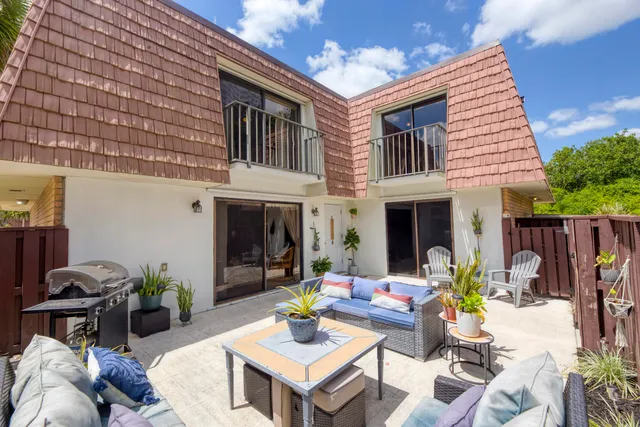 a view of a dinning tables and chairs in a patio